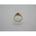 An 18ct hallmarked ruby and diamond set ring, diamonds approx 0.12ct, ring size K/L, approx 2.9