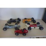 Five Schuco model cars including a tin plate Grand Prix Racer 1070