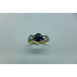 A hallmarked 9ct yellow gold diamond and sapphire ring, size N, approx 2.8 grams, centre stone,