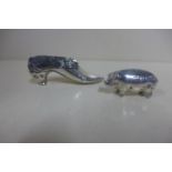 A silver pig pin cushion, and a silver shoe pin cushion, 8cm long, both have some small dents,