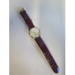 A Gentleman's Omega 9ct gold manual wind wristwatch on a faux crocodile strap, case 33mm wide,