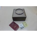 A Chinese white metal bangle with rotating outer - 35 grams, with certificates and box