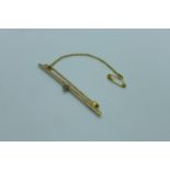 A 15ct yellow gold bar brooch, set with a single white stone, 5.5cm long, approx 3 grams, marked