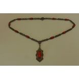 An unusual silver marcasite and coral set necklace, in generally good condition