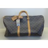 A Louis Vuitton monogram keepall 50 - 56x26x28cm, with padlock and keys, No 303, with luggage label,