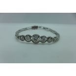 An 18ct white gold diamond bracelet, the eleven old cut diamonds are graduated in size and