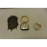 A silver heart shaped pill box with engraved ribbon and floral decoration, a silver coin purse,