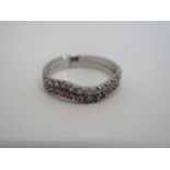 A white metal two piece diamond and ruby ring, size O, approx 3 grams, generally good