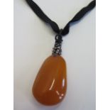 A butterscotch amber pendant - 45x25x15mm - approx weight 10 grams