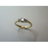 An 18ct hallmarked yellow gold three stone diamond 0.35ct - weight approx 3 grams, size N - as new