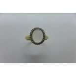 A 9ct hold hallmarked moonstone and diamond ring, size Q, approx 2.9 grams, in good condition