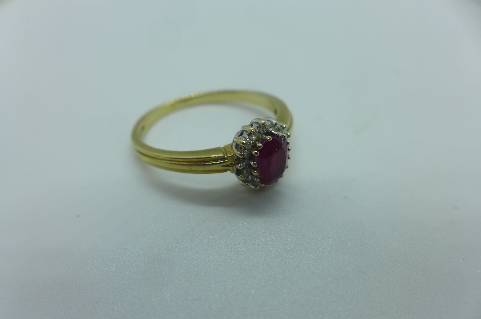 A hallmarked 9ct yellow gold ruby and white stone ring, size X, approx 3.6 grams, generally good