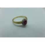 A hallmarked 9ct yellow gold ruby and white stone ring, size X, approx 3.6 grams, generally good