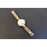 A 9ct yellow gold ladies manual wind wristwatch on a 9ct strap, total weight approx 17 grams