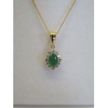 An 18ct yellow gold emerald and diamond pendant, on an 18ct chain, as new, approx weight 2.7 grams