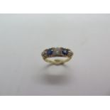 An 18ct hallmarked diamond and sapphire five stone ring, size K/L, approx 4.1 grams, centre