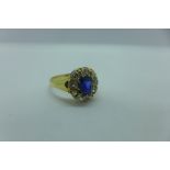 An 18ct gold diamond and sapphire ring, Size M, approx 3.6 grams, head approx 11x10mm - minor