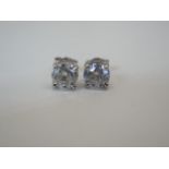 A pair of hallmarked 18ct gold diamond earrings, each approx 0.60ct, approx 2 grams, in good