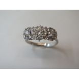 A hallmarked 18ct white gold cluster ring, size W, approx 5.7 grams, in good condition - minor usage