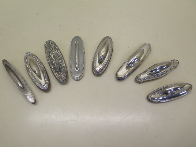 A collection of eight silver nail buffs