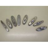 A collection of eight silver nail buffs