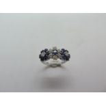 A hallmarked 18ct white gold diamond and sapphire triple cluster ring, size L, approx 3.5 grams,