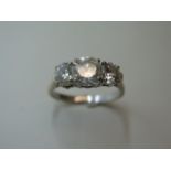 An impressive 18ct white gold three stone diamond ring, the centre stone approx 1.9ct, side stones