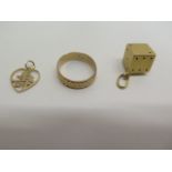 An 18ct dice charm and an 18ct band ring, total approx 5.4 grams, and a 14ct pendant, approx 0.5