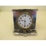 A silver travel watch/clock case with an associated Asprey 8 day watch, not working, glass