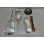 A silver back four piece dressing set and a weighted silver dish