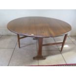 An Ercol Golden Dawn drop leaf dining table, length 128cm, height 72cm, width 22cm, opening to