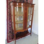 An Edwardian inlaid mahogany serpentine fronted two door display cabinet with an under tier, 170cm x