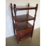 A Victorian mahogany three tier whatnot - with a base cupboard 127cm tall, 60cm x 43cm