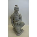 A reproduction figure of a terracotta warrior featuring a kneeling soldier in armour, height 36cm,