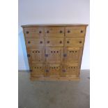 A good quality waxed pine bank of six drawers and six cupboards, 111cm wide x 122cm high
