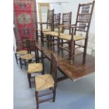 An oak refectory draw leaf dining table with eight Cotswold oak chairs with rush seats including two