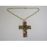 A unique 18ct yellow gold cross set with thirty-four coloured stones on 18ct yellow gold figure