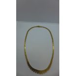 A 14ct tapered fringed necklace, length 41cm, weight approx 20.5 grams, with valuation, clean