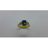 An emerald and diamond gold ring, size P/Q, approx 3.9 grams, tests to approx 18ct, no hallmark,