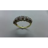 An impressive 9ct diamond ring set with seven stones, round brilliant cut, totaling just under 1ct