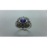 A very pretty 18ct white gold diamond and sapphire ring, the central sapphire of very good colour,