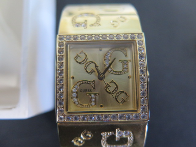 A ladies Guess gold tone and rhinestone wristwatch and a steel Givanchy wristwatch, require - Image 2 of 5