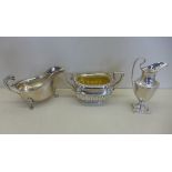 A silver twin handled sugar bowl, Birmingham 1902 - a silver cream jug Chester 1906 - and a silver