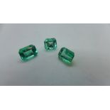 Three baguette cut emeralds, largest approx 7mm x 5mm x 3.8mm - no gem report