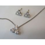 An 18ct white gold three stone diamond pendant on chain, total diamonds approx 1ct with matching