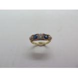 An 18ct hallmarked diamond and sapphire five stone ring, size K/L, approx 4.1 grams, centre