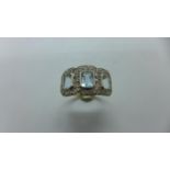 An 18ct aquamarine and diamond ring, marked 18ct, ring size N, approx 4.4 grams, centre stone approx