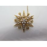 An 18ct gold diamond and seed pearl star shape brooch, the central diamond measuring approx 0.