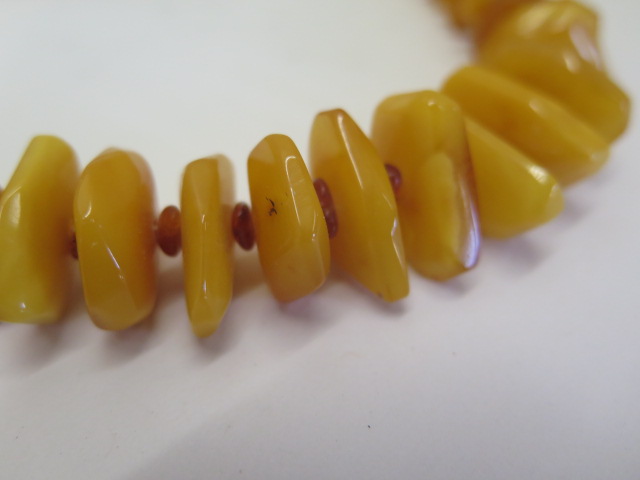 Two strings of natural polished amber beads, deep honey and egg yolk colours, larger string 74cm - Image 2 of 4