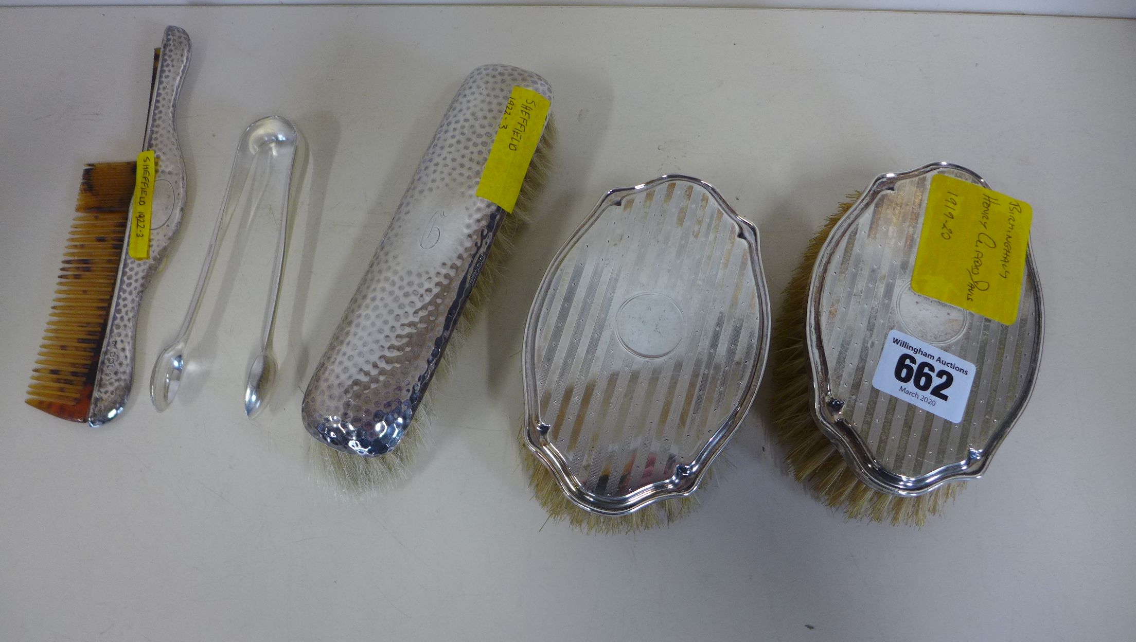 A pair of silver backed brushes by Henry Clifford Davis 1919, a single brush with matching comb back